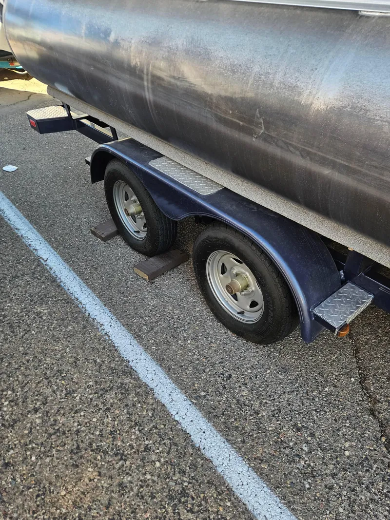 Slide: The Image of Trailer wheels of a 2018 Crest 200 CA boat parked on asphalt. - 5