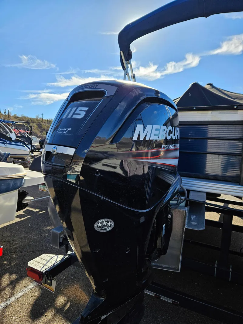 Slide: The Image of Mercury 115 outboard motor on a 2018 Crest 200 CA boat under a clear sky. - 6