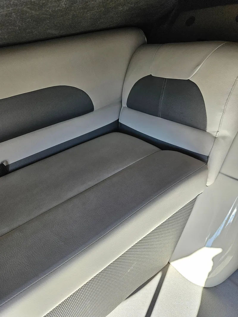 Slide: The Image of 2018 Crest 200 CA boat interior with gray and white cushioned seating. - 8