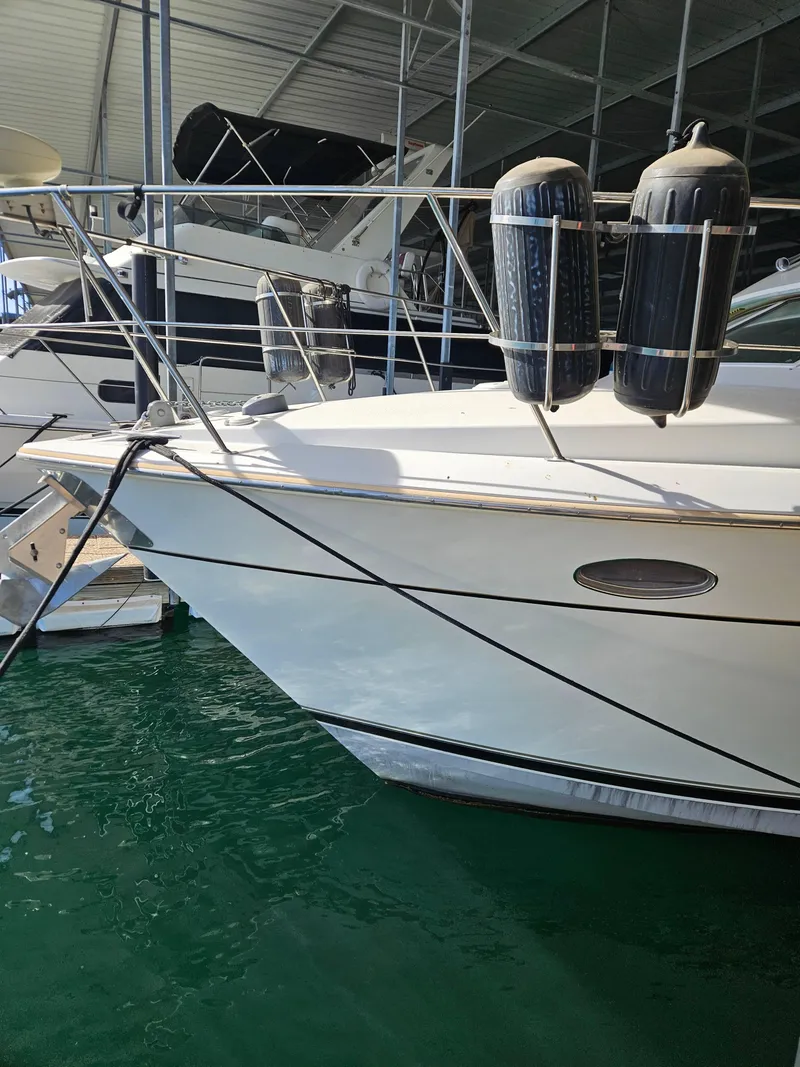 Slide: The Image of 1997 Carver 455 Aft Cabin Motoryacht docked in marina, side view with fenders. - 1