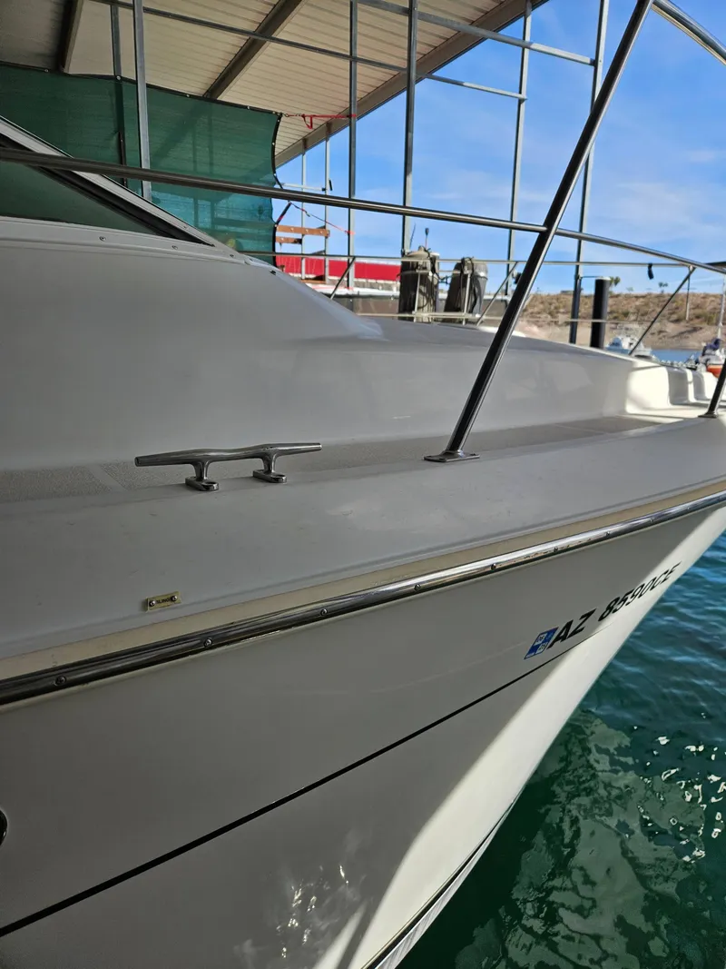 Slide: The Image of 1997 Carver 455 Aft Cabin Motoryacht docked, side view with railing and cleat. - 10