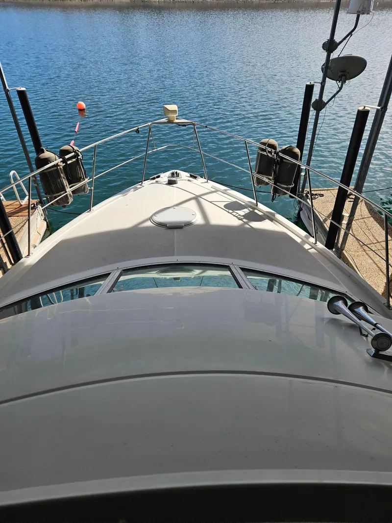 Slide: The Image of 1997 Carver 455 Aft Cabin Motoryacht docked on calm water. - 12