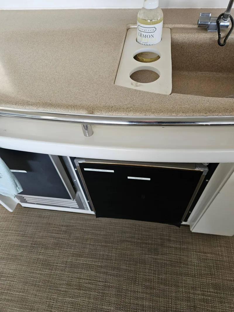 Slide: The Image of 1997 Carver 455 Aft Cabin Motoryacht kitchen sink area with countertop and storage. - 13