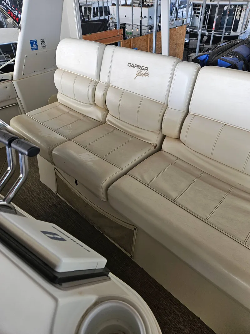 Slide: The Image of 1997 Carver 455 Aft Cabin Motoryacht interior seating, featuring cream leather upholstery. - 15