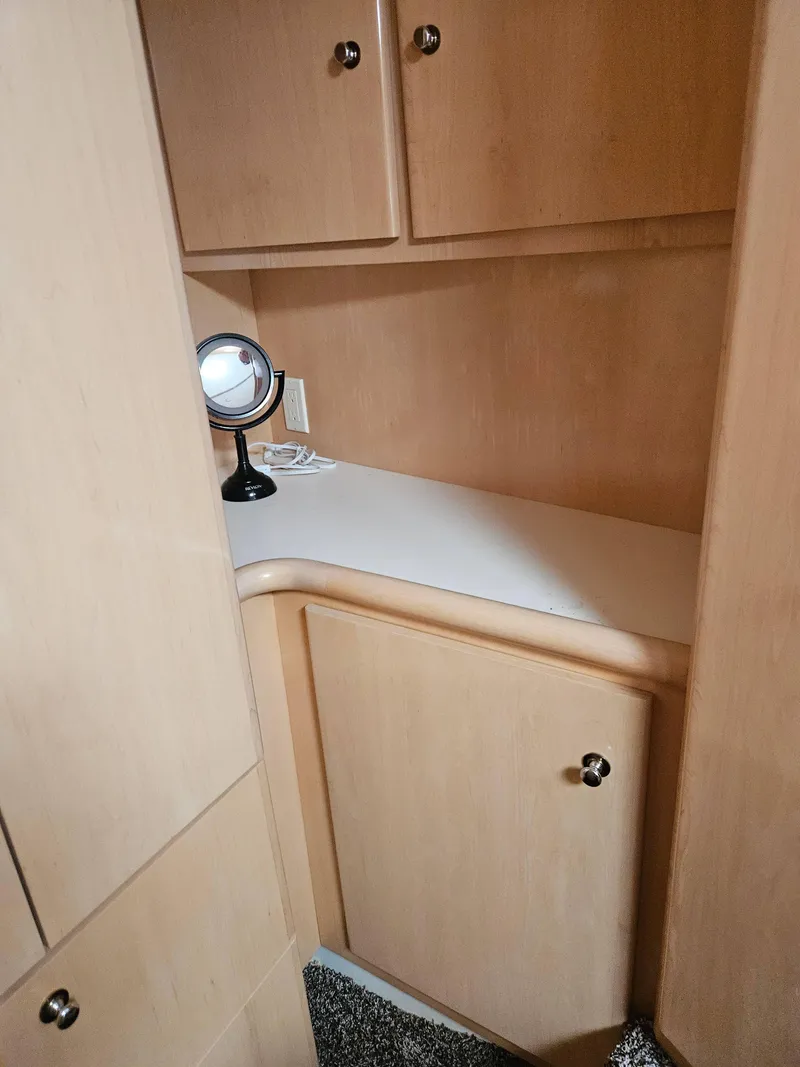 Slide: The Image of 1997 Carver 455 Aft Cabin Motoryacht interior with wooden cabinets and a vanity mirror. - 16