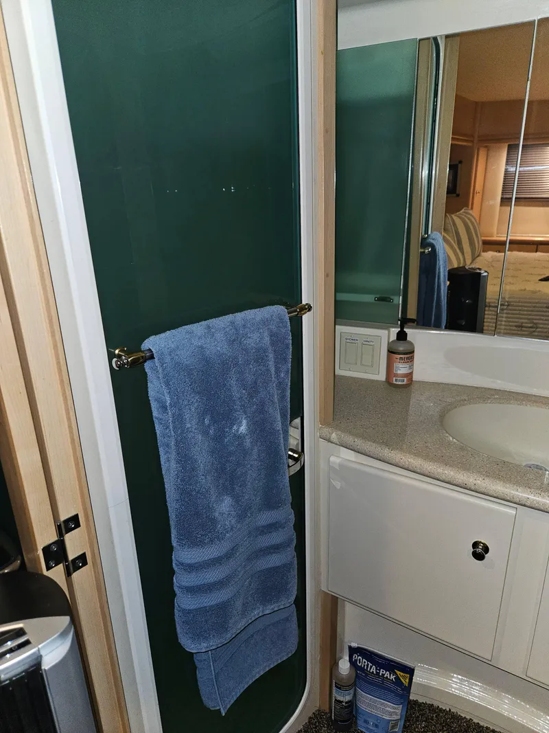 Slide: The Image of Bathroom interior of 1997 Carver 455 Aft Cabin Motoryacht with towel and toiletries. - 19