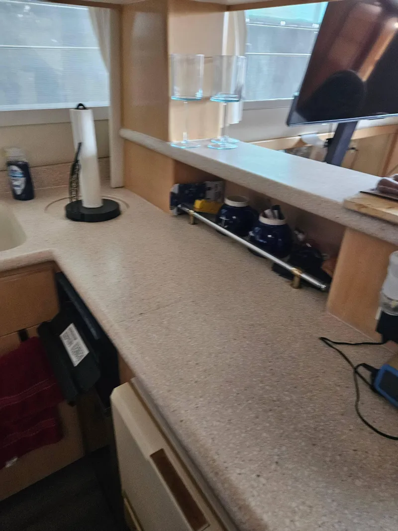 Slide: The Image of 1997 Carver 455 Aft Cabin Motoryacht interior kitchen counter with appliances and decor. - 21