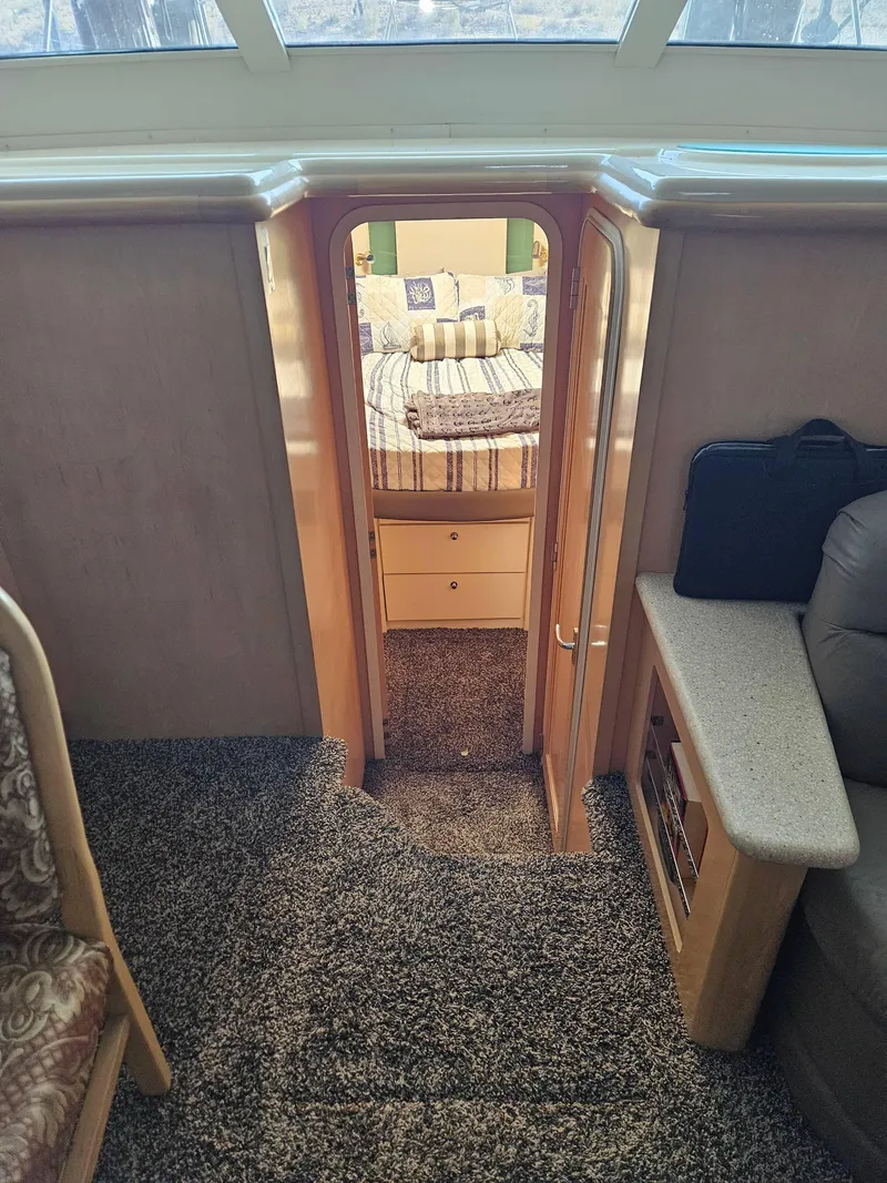 Slide: The Image of Interior view of 1997 Carver 455 Aft Cabin Motoryacht, featuring cozy carpeted stairs and bedroom. - 22