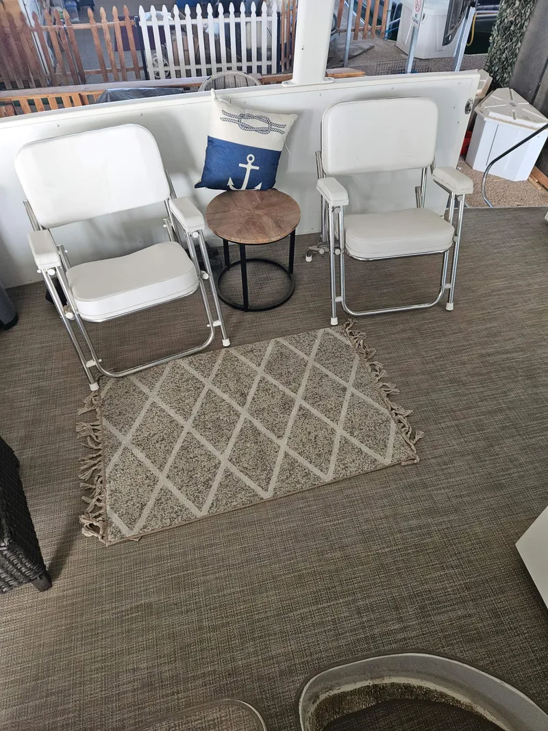 Slide: The Image of Two white chairs and a small table on a 1997 Carver 455 Aft Cabin Motoryacht deck. - 25
