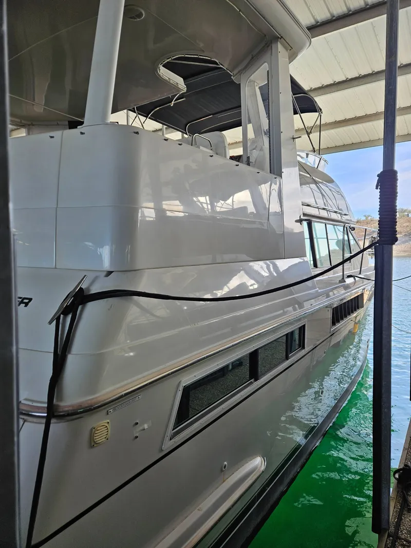 Slide: The Image of 1997 Carver 455 Aft Cabin Motoryacht docked under a covered marina. - 3