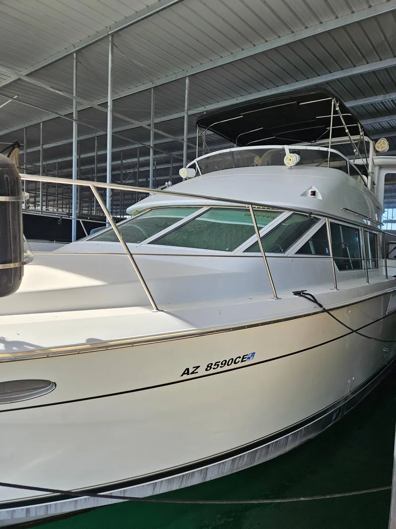 Slide: The Image of 1997 Carver 455 Aft Cabin Motoryacht docked in a covered marina. - 5