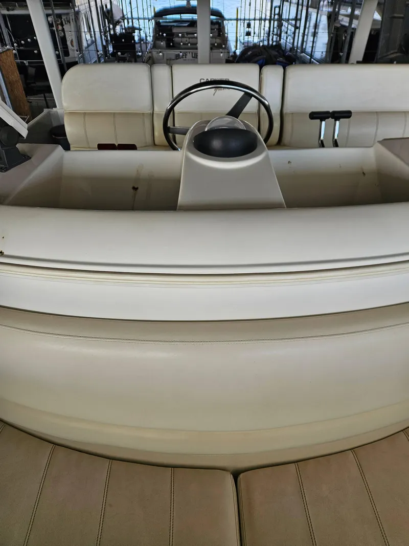 Slide: The Image of 1997 Carver 455 Aft Cabin Motoryacht helm with steering wheel and controls. - 7