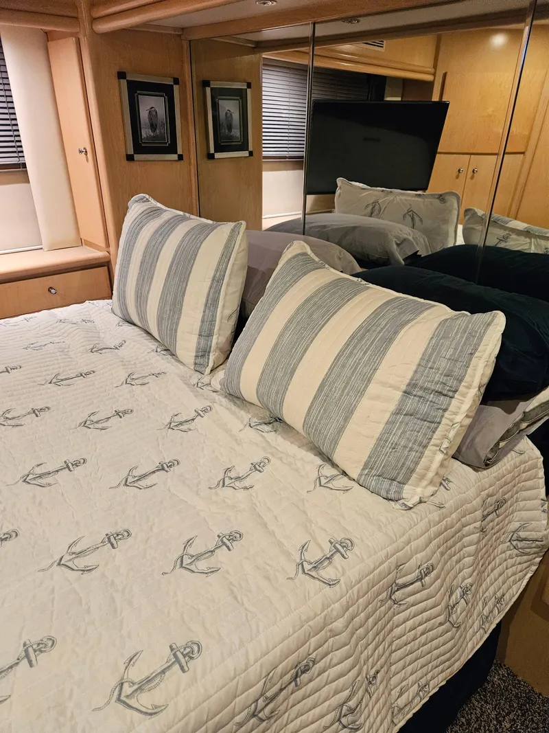 Slide: The Image of Cozy bedroom in 1997 Carver 455 Aft Cabin Motoryacht with nautical-themed bedding. - 8