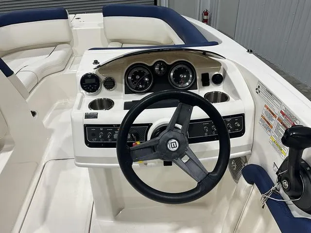 Slide: The Image of 2016 Bayliner 190 Deck Boat cockpit with steering wheel and instrument panel. - 11