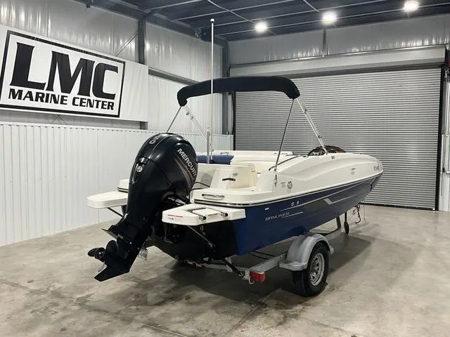 Slide: The Image of 2016 Bayliner 190 Deck Boat in showroom, featuring Mercury outboard motor. - 5