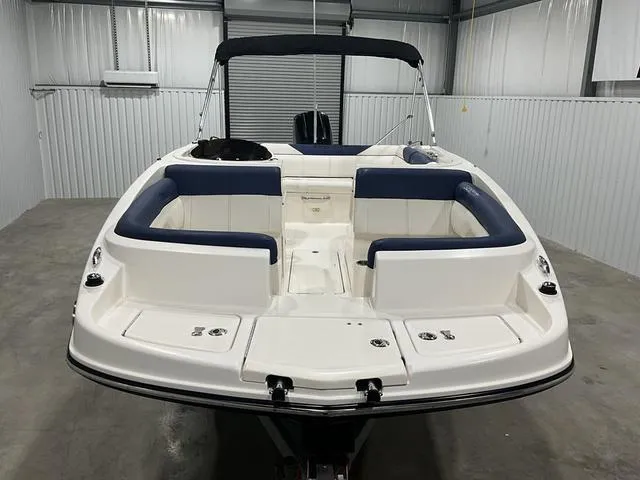 Slide: The Image of 2016 Bayliner 190 Deck Boat in storage, featuring spacious seating and sleek design. - 8