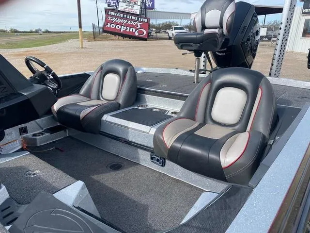 Slide: The Image of 2019 Ranger Z518 boat interior with dual seats and steering wheel, parked outdoors. - 14