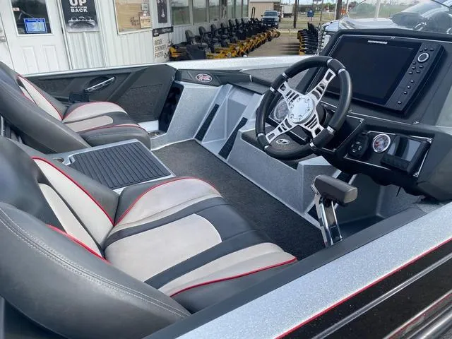 Slide: The Image of 2019 Ranger Z518 boat interior with modern dashboard and dual seating. - 7