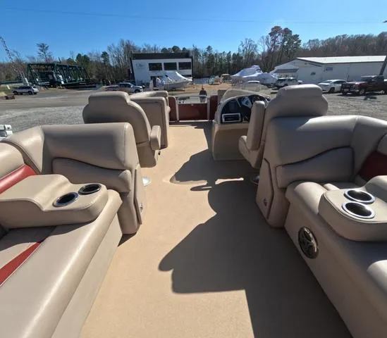 Slide: The Image of 2015 Sweetwater SW 2286 SLC pontoon boat interior with beige seating and cup holders. - 11