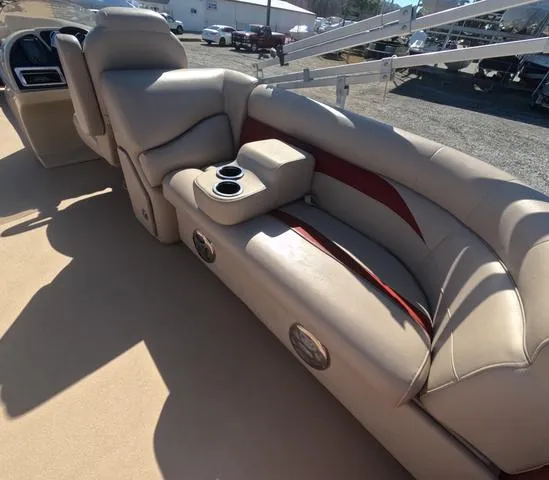 Slide: The Image of Luxurious seating on 2015 Sweetwater SW 2286 SLC boat with cup holders and beige upholstery. - 12