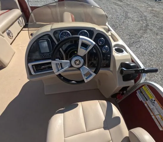 Slide: The Image of 2015 Sweetwater SW 2286 SLC boat dashboard with steering wheel and control panel. - 17