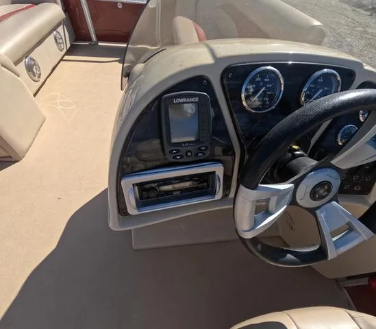 Slide: The Image of 2015 Sweetwater SW 2286 SLC boat dashboard with steering wheel and navigation system. - 18