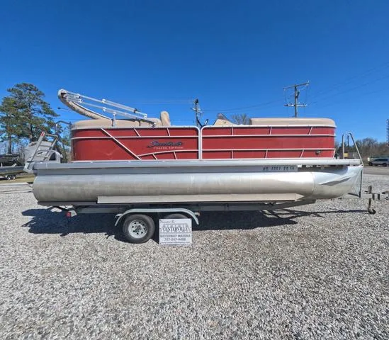 Slide: The Image of 2015 Sweetwater SW 2286 SLC pontoon boat on trailer, parked on gravel lot. - 4