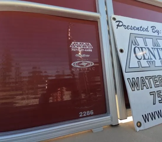 Slide: The Image of 2015 Sweetwater SW 2286 SLC boat with Centerville and Nautic logos, partial sign visible. - 5