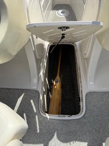 Slide: The Image of 2007 Tahoe Q7i boat storage compartment with paddle inside. - 11