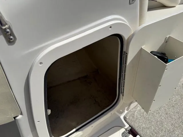 Slide: The Image of Open storage compartment on a 2007 Tahoe Q7i boat, showing interior space. - 12