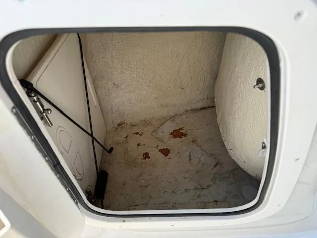Slide: The Image of 2007 Tahoe Q7i storage compartment, open and empty, showing interior details. - 13