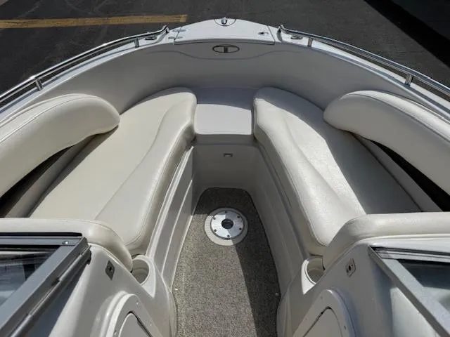 Slide: The Image of 2007 Tahoe Q7i boat interior with white cushioned seating and carpeted floor. - 14