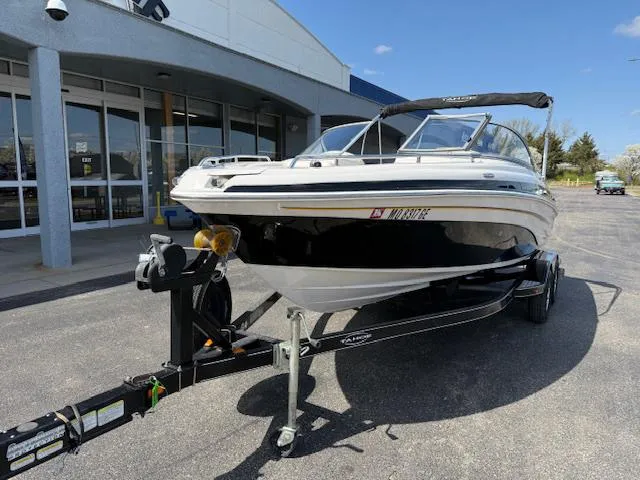 Slide: The Image of 2007 Tahoe Q7i boat on trailer outside a building, sunny day. - 2