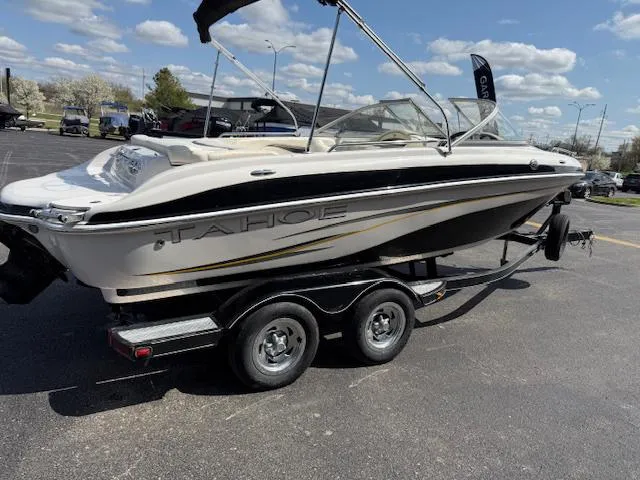 Slide: The Image of 2007 Tahoe Q7i boat on trailer in parking lot under blue sky. - 20