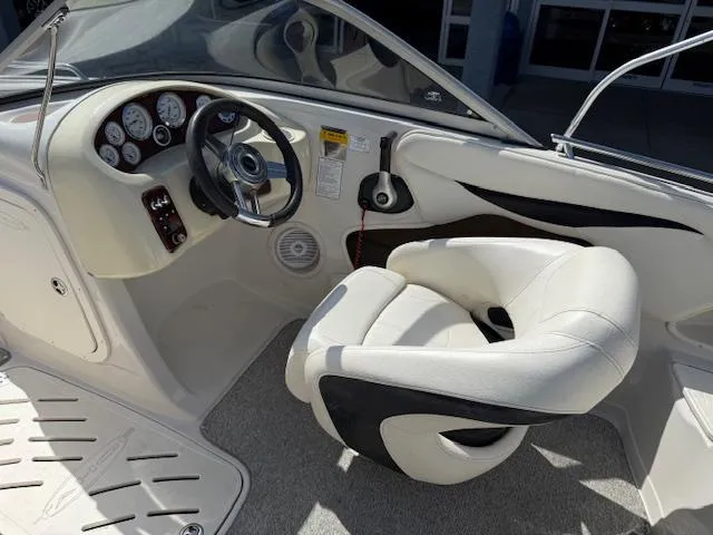 Slide: The Image of 2007 Tahoe Q7i boat interior with steering wheel and white captain's chair. - 7