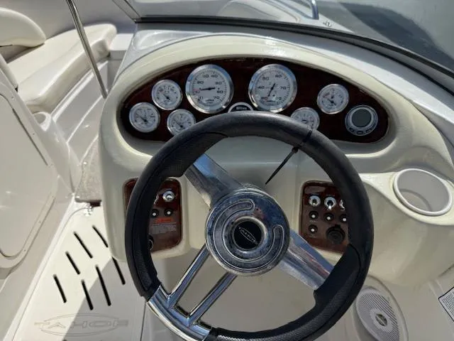 Slide: The Image of Steering wheel and dashboard of 2007 Tahoe Q7i boat with gauges and controls. - 8