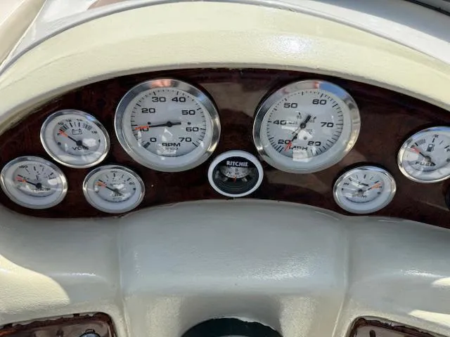 Slide: The Image of Dashboard of a 2007 Tahoe Q7i boat with various gauges and a compass. - 9