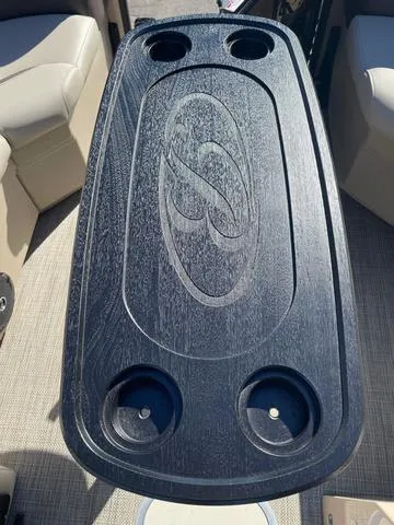 Slide: The Image of 2025 Bentley Pontoons 223 Legacy Swingback table with cup holders and logo design. - 17