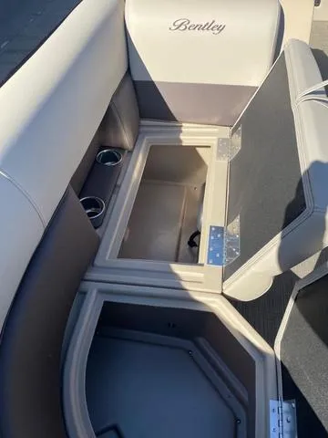 Slide: The Image of 2025 Bentley Pontoons 223 Legacy Swingback interior storage and seating detail. - 21