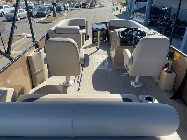 Slide: The Image of 2025 Bentley Pontoons 223 Legacy Swingback interior with beige seating and modern controls. - 22