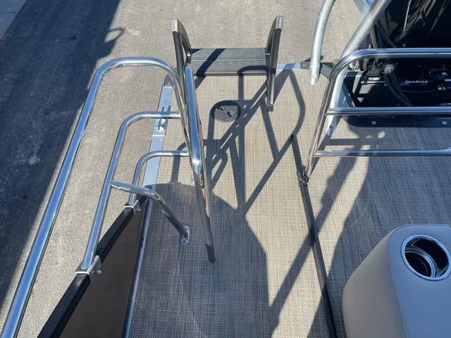 Slide: The Image of 2025 Bentley Pontoons 223 Legacy Swingback deck with stainless steel railing and ladder. - 5