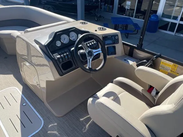 Slide: The Image of 2025 Bentley Pontoons 223 Legacy Swingback dashboard and steering area, featuring modern controls and seating. - 6