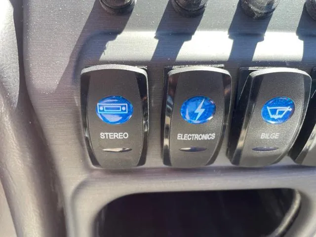 Slide: The Image of Control panel switches on 2025 Bentley Pontoons 223 Legacy Swingback boat. - 9