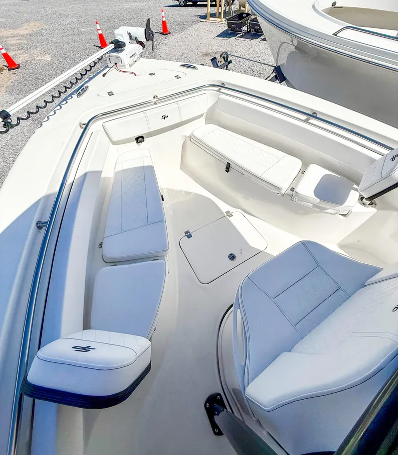 Slide: The Image of 2023 Sea Pro 219 Center Console boat interior with white seating and storage compartments. - 11