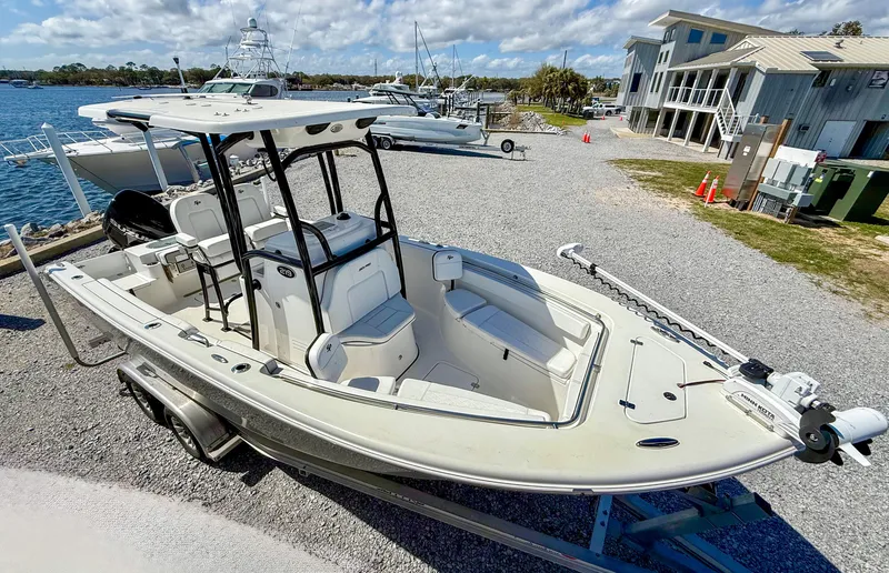 Slide: The Image of 2023 Sea Pro 219 Center Console boat on trailer by waterfront. - 3