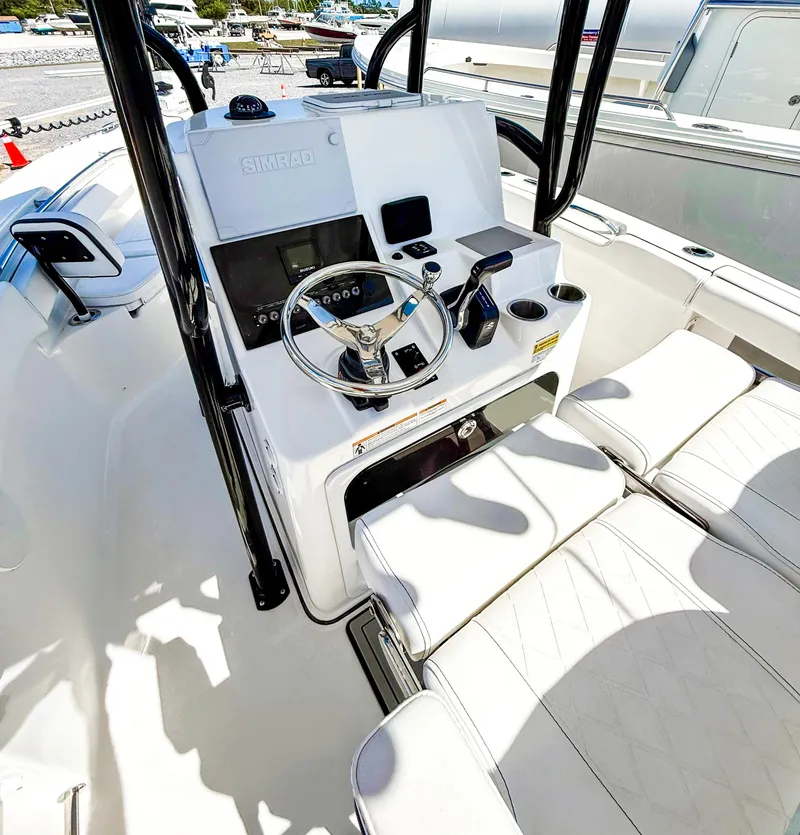 Slide: The Image of 2023 Sea Pro 219 Center Console boat interior with steering wheel and seating. - 7