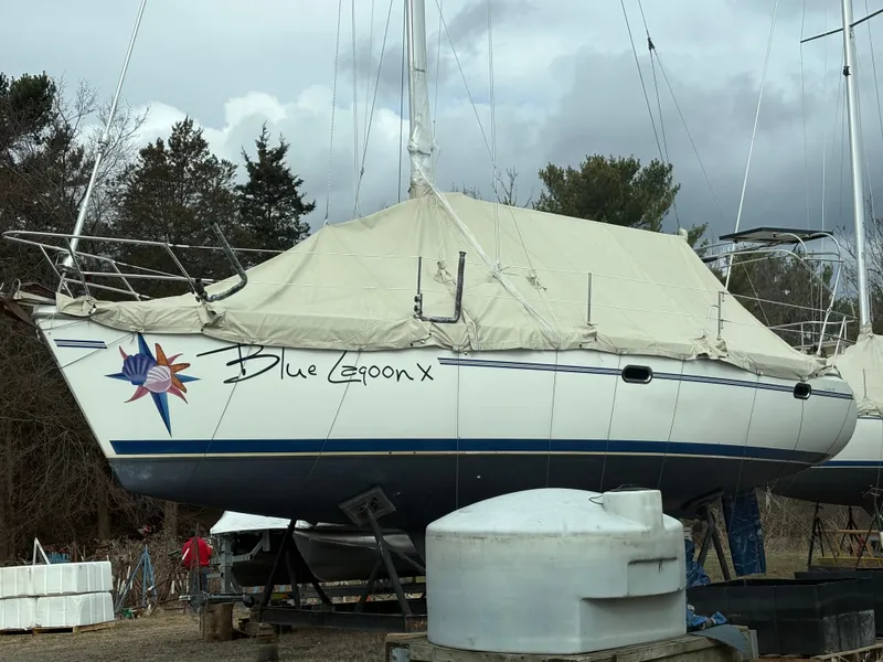 Slide: The Image of Catalina 350 sailboat named "Blue Lagoon X" covered and docked, 2010 model. - 0