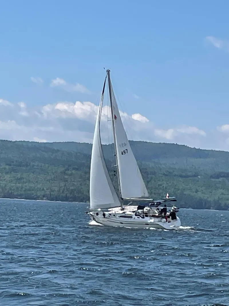 Slide: The Image of Sailboat Catalina 350 (2010) cruising on a lake with scenic mountain backdrop. - 1