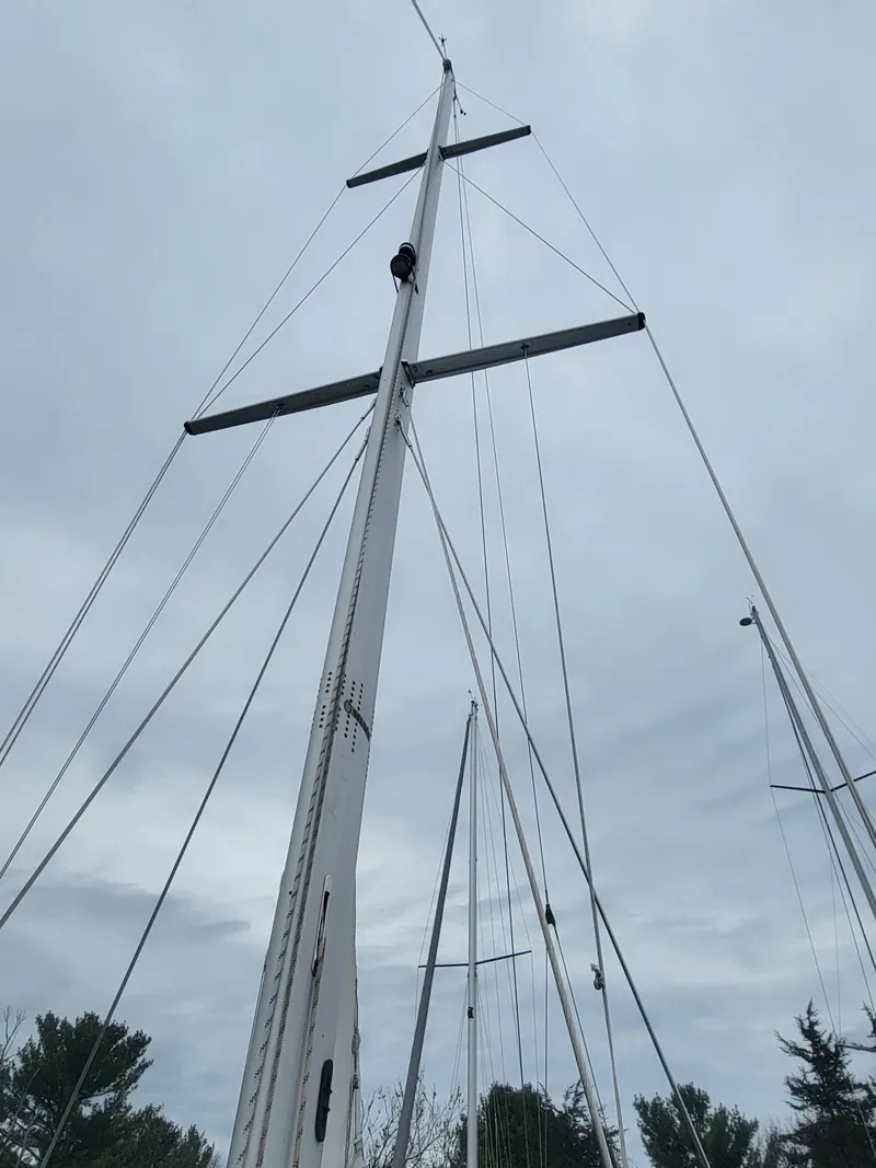 Slide: The Image of Tall mast of a 2010 Catalina 350 sailboat against a cloudy sky. - 18
