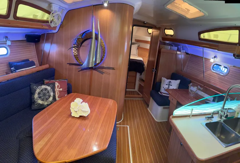 Slide: The Image of Interior of a 2010 Catalina 350 sailboat with wood finish and cozy seating area. - 21